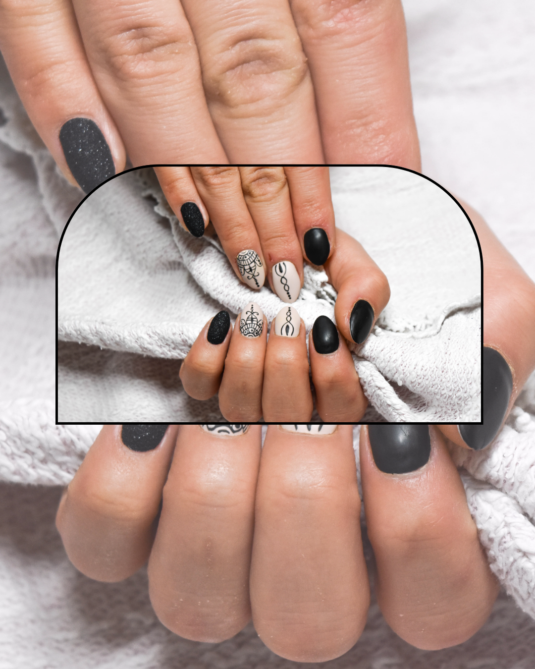 A professional manicure featuring a modern black and white nails design with a glossy top coat on a clean background.